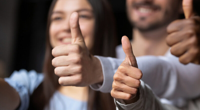 Händer som gör tummen upp och glada ansikten. Foto.